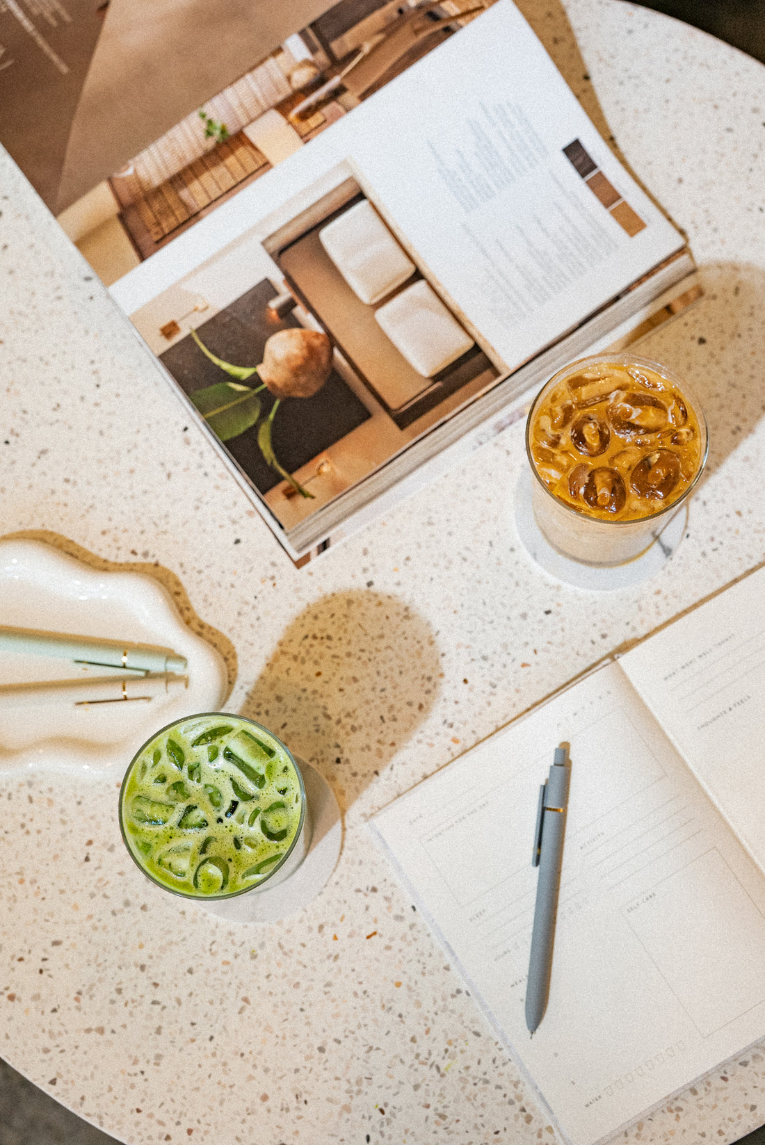 Cozy Tea Loft interior on Mississippi Ave with warm lighting, comfortable seating, and soft olive green branding